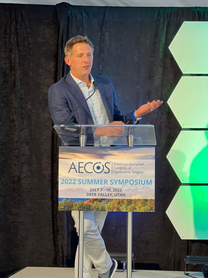 Dr. William Wiley presenting from the podium at the AECOS 2022 Summer Symposium
